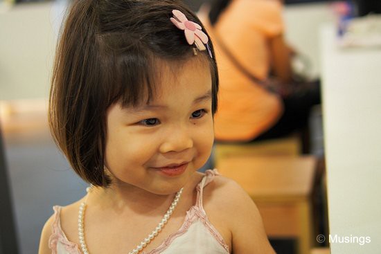 At f1.6 over brunch at Serangoon Nex. Her classmate gave her a faux pearl necklace that she's taken to wearing whenever we go out.