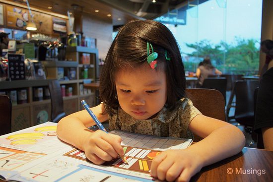 Practising her Chinese character strokes while waiting for our breakfasts to be served. She plows through those workbooks.