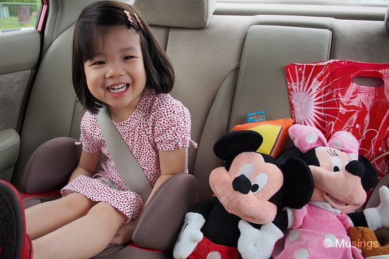 Just check out how happy she was on our way home. She spent the ride home adjusting (and readjusting) the two toys beside her.=)