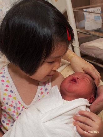 Hannah couldn't wait to stroke her new baby brother when he started wailing. She was also very eager to carry him too. One ward nurse remarked that many older sisters either don't want to or grimace!