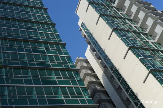 Sleek modern-looking apartment lines against a bright morning sun.