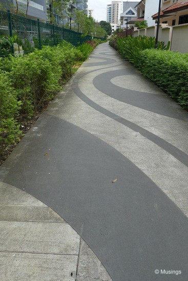 The pedestrian path just outside the compound has been fitted with decorative wave patterns. Nice!
