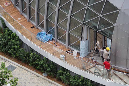 The Badminton Dome has been getting wood decking around it. Workers were also (finally) mounting up its door frame too.