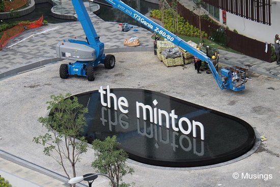 The front signage's water feature is complete - nice! Check out the almost perfect reflection of the condo's name.