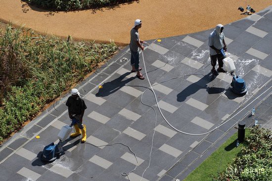 Workers scrubbing the tiles at Fun World.