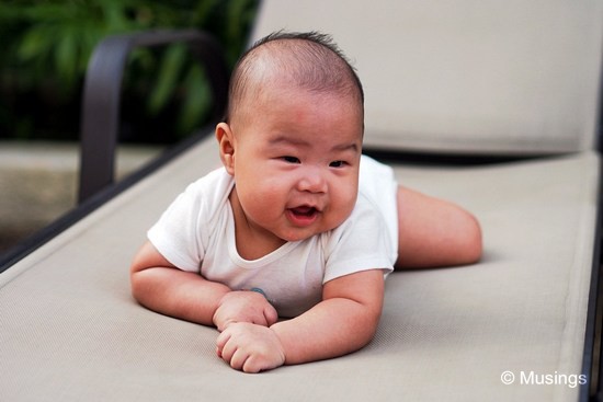 Peter seemed to enjoy his Tummy Time at the poolside deck chairs. Might be just that it's a new physical environment for him, what in the cool mid-morning breeze. Taken at 45mm f1.8.