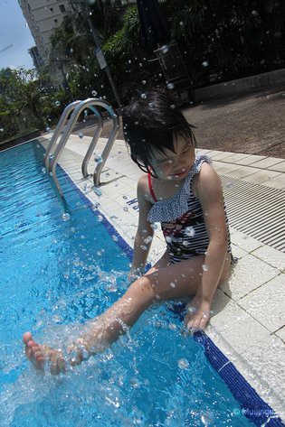 At the pool, and perfect for a swim on a hot and scorching noon-time Sunday. Just 30 minutes though and she got a tan. She needs to get into the sun a lot more.