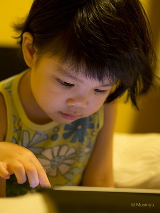 Hannah having her 5 minutes of evening iPad time. Thankfully she's still not too distressed when that time is denied to her - we're still quite conscious about her not getting hooked so early onto these electronic gadgets. Taken at 45mm f1.8.