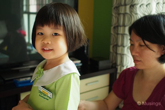 Getting dressed in her school uniform and ready at home first