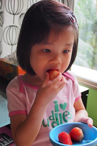 3 Years 10 Months in April 2013, and munching on strawberries. Like Mommy, she loves fruits that Daddy doesn't enjoy (that includes tomatoes, grapes, kiwi and strawberries!