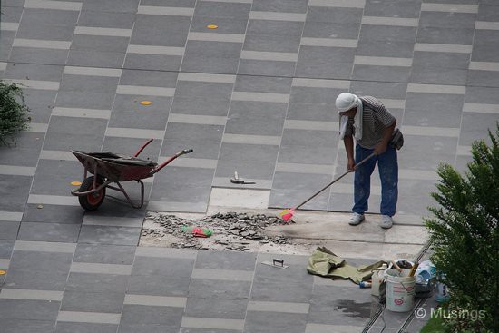 This was odd - a worker cleaning up debris near the Main Pool. It looked like the tiles had been removed, and now need replacements.