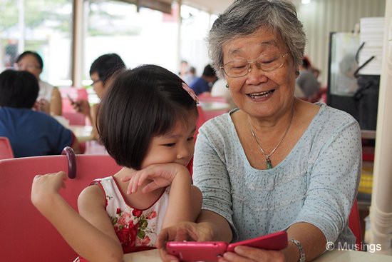 Mom has discovered taking grandchildren photos on her handphone, and sharing the joy of her empowerment with Hannah.