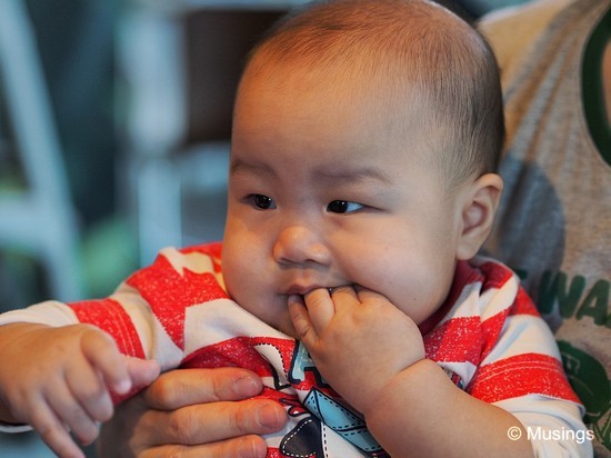 Peter chews his fingers a lot more than Hannah did at this age. Taken using the 45mm, and wide-open at f1.8. I'm still getting a handle of this short telephoto lens, and frequently to stretch myself as far as I can when shooting over a dining table. The lens is wonderfully sharp in its image center.