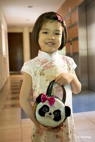 Hannah in her Cheongsam on the first day of CNY. She's carrying a little Panda bag ("To hold all my ang pows!") that a visiting friend from the US brought along last year.