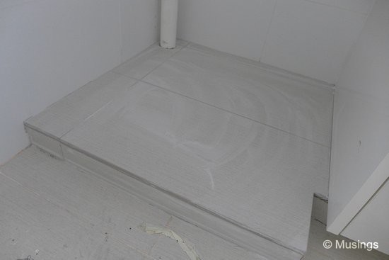 The newly laid base for our dishwasher. Our designer was able to get tiles of the same type as our existing kitchen tiling, making for a pretty seamless integration with the floor.
