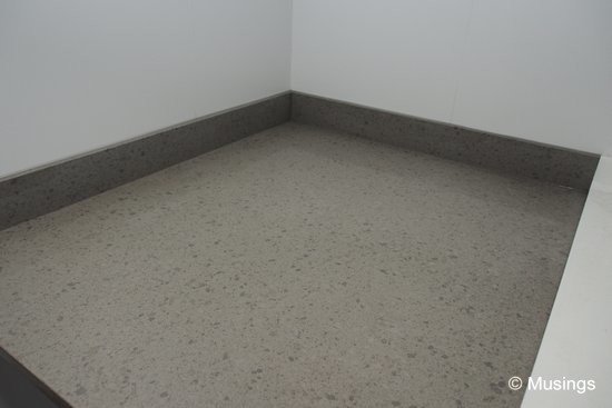 The quartz surface on top of the dishwasher cabinet. We noted a month ago that our designer suggested not choosing an exact match for this surface against the rest of the kitchen countertop, since there will be a height difference between this cabinet and the existing countertop. 