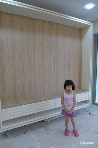 Yep, it's big enough to put a 100" LED TV, but no I got no money for one! Hannah asked why was our Living Hall TV feature wall so large, and proceeded to make a face while posing for a picture.:)