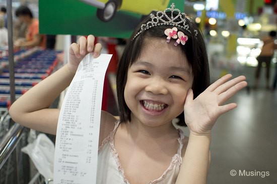 Not sure what she's thrilled about, but that's the Fairprice Supermarket cash receipt for our groceries.