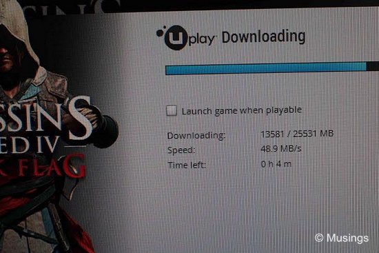 Installing Assassin's Creed IV: Black Flag, just for the heck of it. Check out the download speed: not quite 1 Gbps as the connection has gone through two routers before reaching this PC, but very good for our needs.