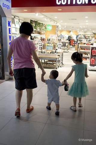 A minder on each hand. Won't be long before he discovers running - then we'll be in trouble.