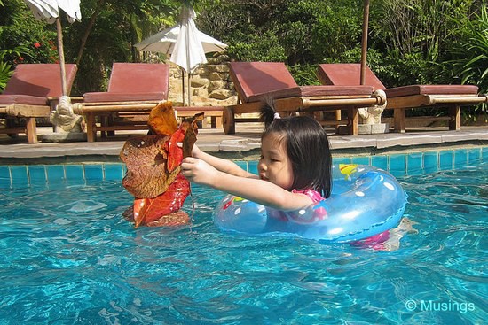 Our girl in her usual eco-friendly and helpful self. She swam around the large main pool picking up leaves. At least she's channeling her energy into doing useful things. Maybe the Resort will give us discounts for her contributions! 