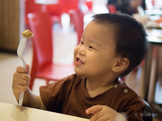 Peter has learned how to handle eating utensils. 