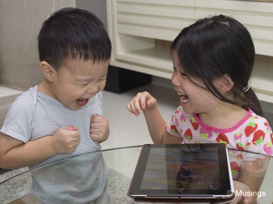 Using the 12-40mm f2.8. The two kids totally entertained by a collaborative session of Crossy Road. No, there's no such mode of play - but Hannah laughs when her chicken gets run over, and Peter will, watching his sister's reaction, laugh in sync too LOL.