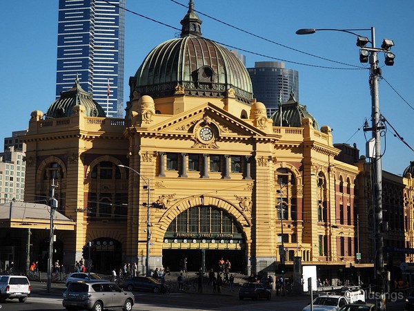 Flinders Street Station with its ornate facades and the clock right above the main entrance.