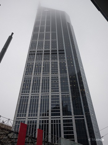 Low-level mist covering the top floors of skyscrapers.